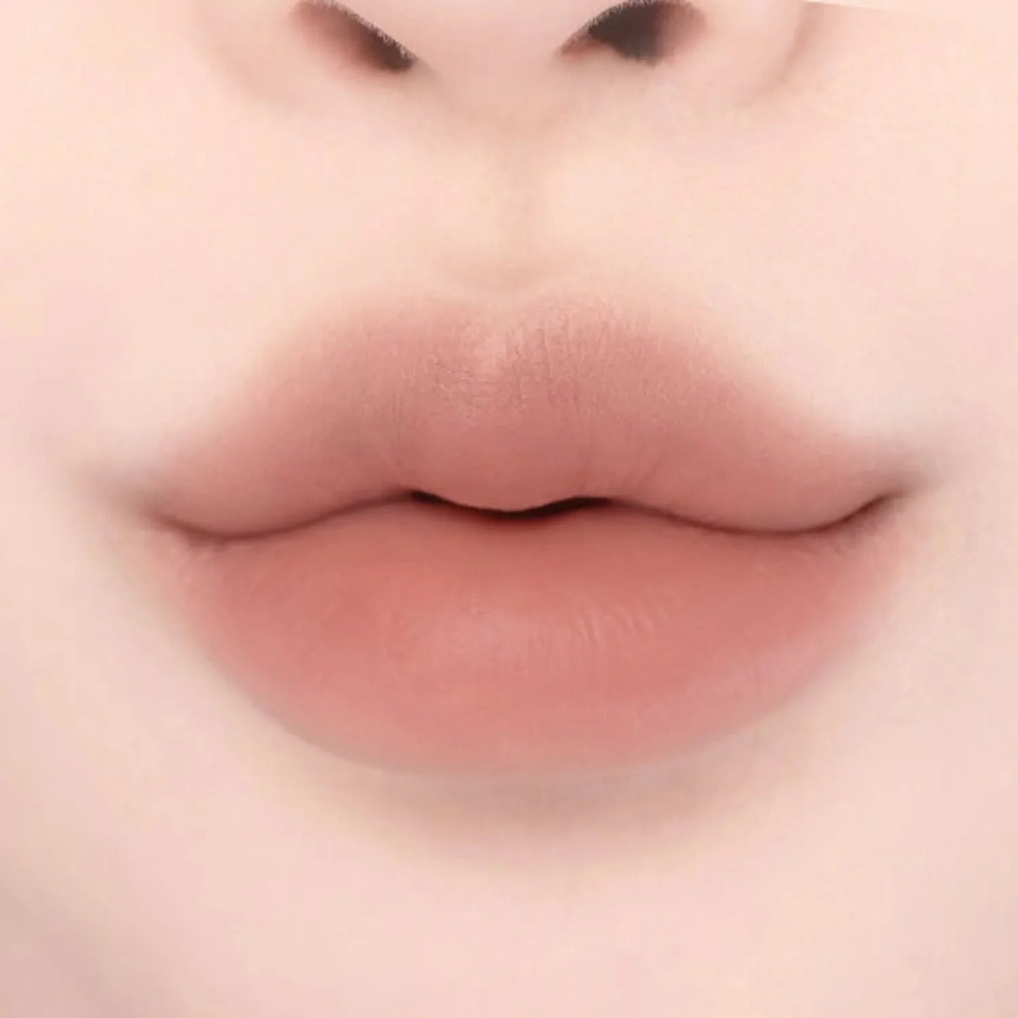 Lips with Lilybyred Smiley Lip Blending Stick 0.8g in a peachy nude tone, demonstrating natural lip contour and even color payoff.