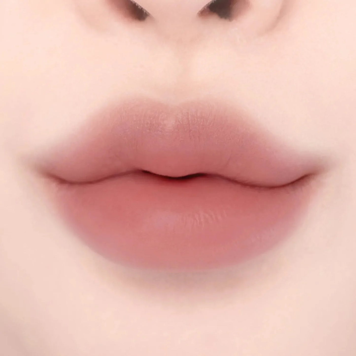 Lips wearing Lilybyred Smiley Lip Blending Stick 0.8g in a rosy nude shade, perfect for everyday wear with a smooth, blended finish.