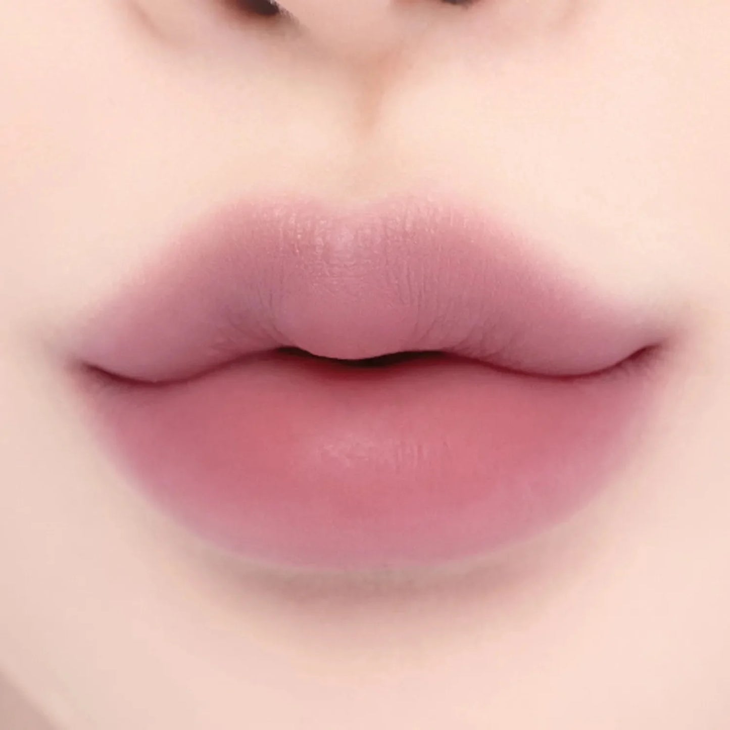 Lips with Lilybyred Smiley Lip Blending Stick 0.8g in a vibrant pink hue, showcasing bold color and seamless blending effect.