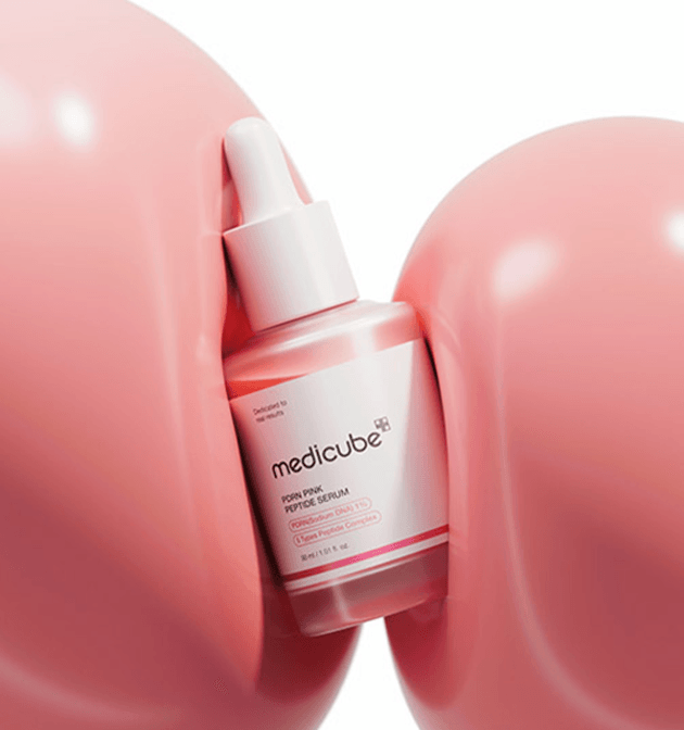 medicube treatment serum styled with minimal skincare tools, suggesting a clinical-grade routine.