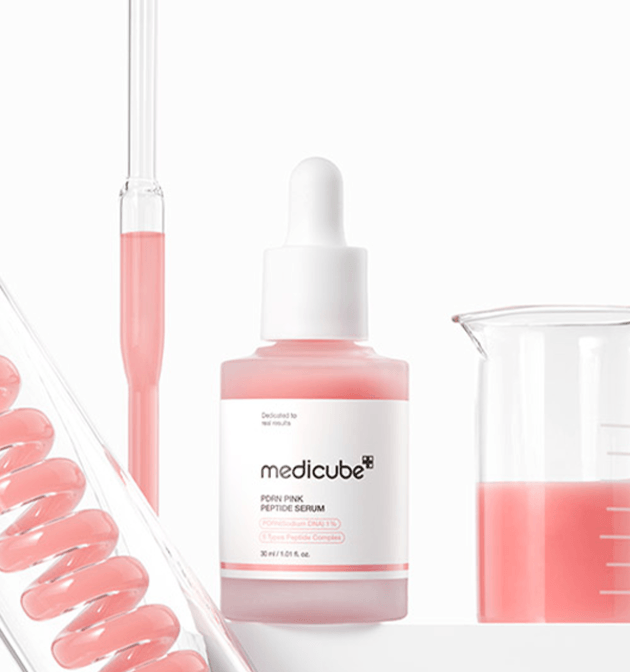 Transparent bottle with metallic cap placed on a reflective surface, conveying a premium skincare aesthetic.