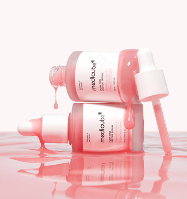 Pink-toned serum captured mid-drop, emphasizing skin-rejuvenating ingredients and texture clarity.