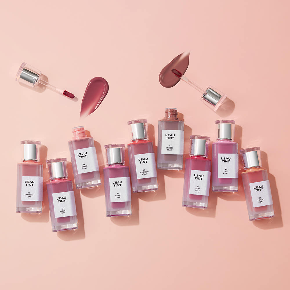 BBIA L'eau Tint 4.5g in 9 colors displayed on a pink background with open applicators showing glossy texture. Ideal for vibrant, weightless lip color.