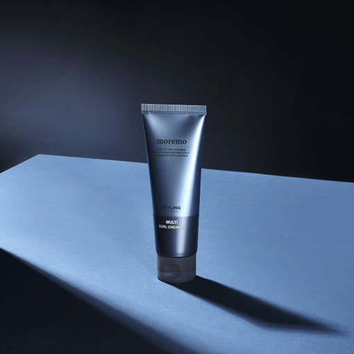 moremo For Men Multi Curl Hair Cream C 120ml standing on a blue and black surface. Curl styling cream that protects and enhances hair.