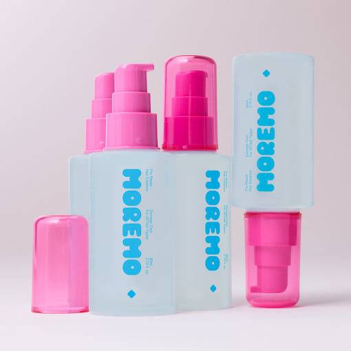 Close-up of Moremo Pro Repair Essence bottles with pink pumps, highlighting the lightweight formula for hair damage repair.