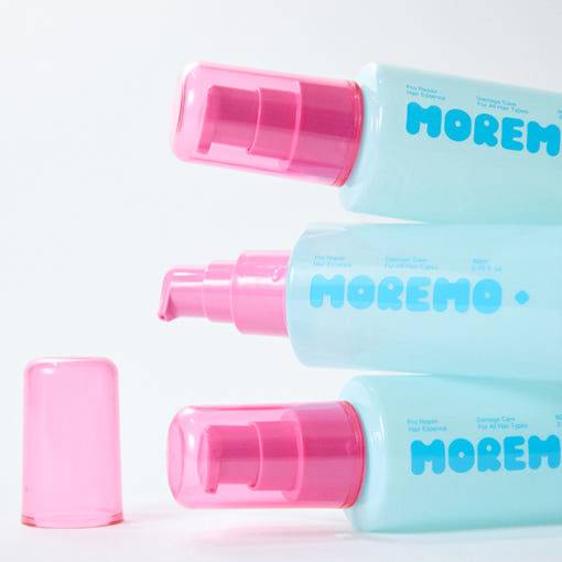Smiling woman with healthy, shiny hair next to Moremo Pro Repair Hair Essence 80ml, promoting smoothness and shine benefits.