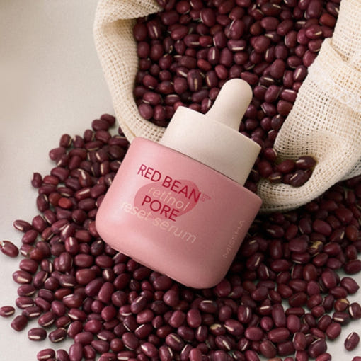 MISSHA Serum - Retinol Pore Reset with red bean extract in a pink dropper bottle surrounded by red beans. Ideal for pore care and hydration.