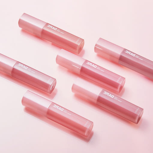 Flat lay of MISSHA Dare Tint Dewy Drop 4.3g in 6 colors, showcasing elegant pink tubes ideal for hydrating, glossy lip makeup.