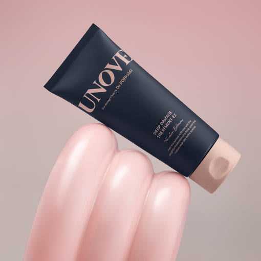 UNOVE Deep Damage Treatment EX 207ml tube displayed on glossy pink surface, ideal for restoring chemically damaged hair with keratin care.