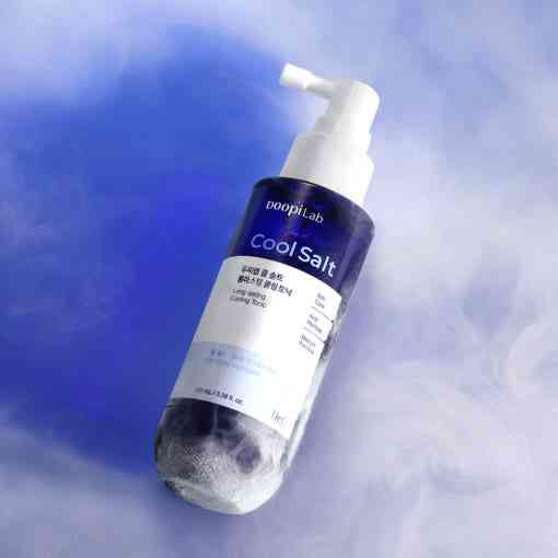 Dr.G Cooling Tonic - Scalp Refresh 100ml lying on a cool mist surface, emphasizing its oil control and instant cooling benefits for the scalp.