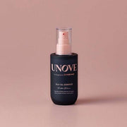 UNOVE Silk Oil Essence 70ml in matte black bottle with pump, perfect for restoring shine and softness to damaged hair.