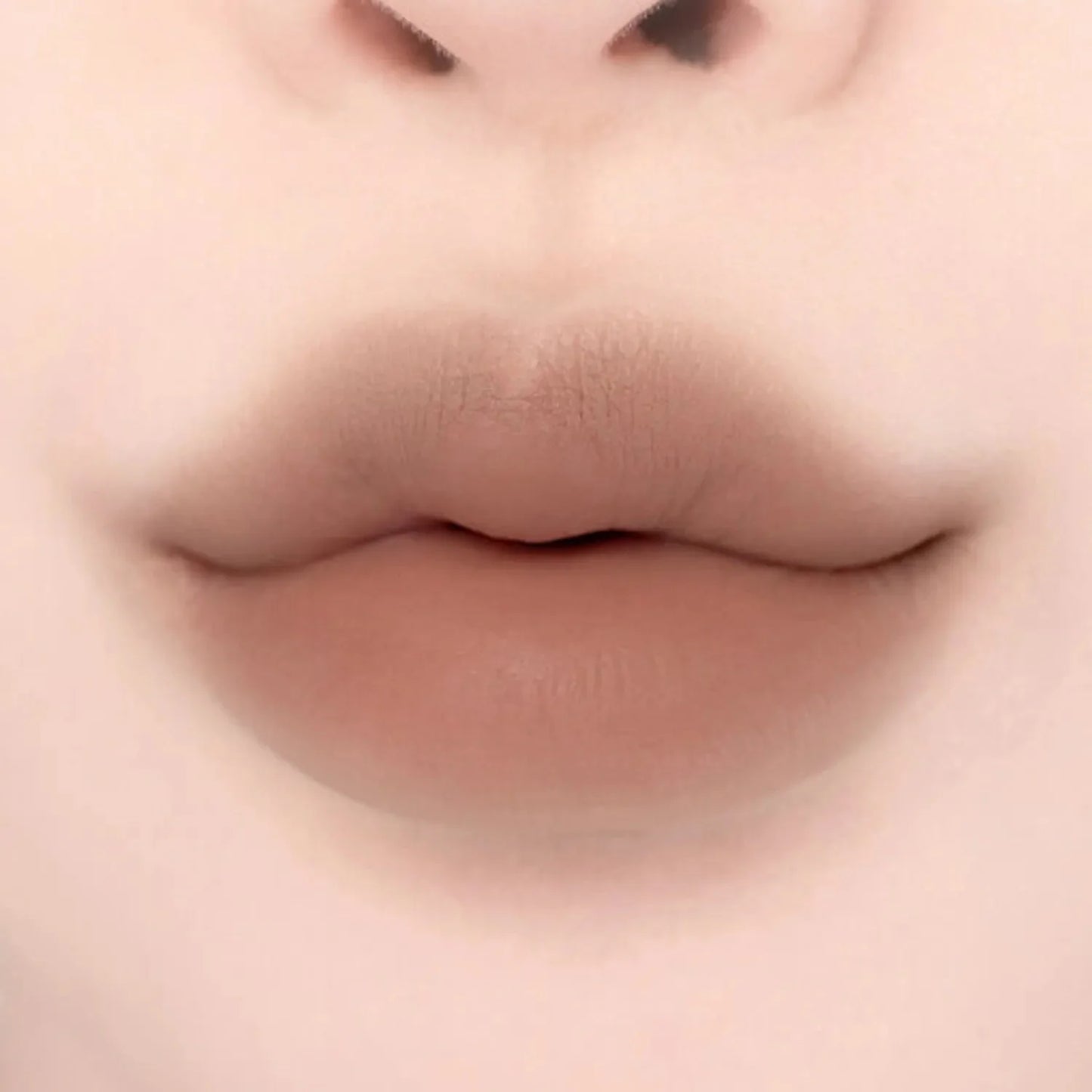 Lips with Lilybyred Smiley Lip Blending Stick 0.8g in a warm beige tone, offering a natural, plump look with soft matte texture.
