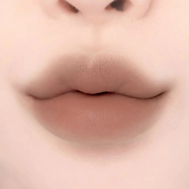 Lips with Lilybyred Smiley Lip Blending Stick 0.8g in a warm beige tone, offering a natural, plump look with soft matte texture.