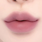 Lips with Lilybyred Smiley Lip Blending Stick 0.8g in a vibrant pink hue, showcasing bold color and seamless blending effect.