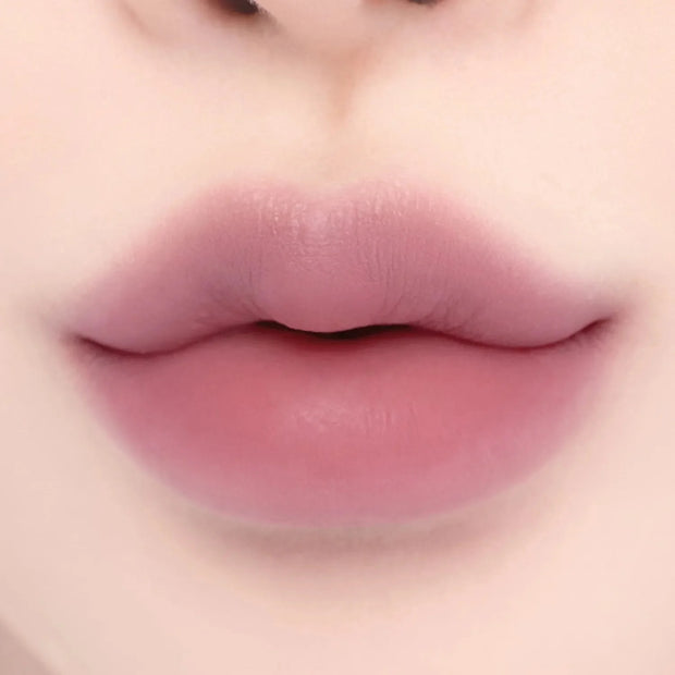 Lips with Lilybyred Smiley Lip Blending Stick 0.8g in a vibrant pink hue, showcasing bold color and seamless blending effect.