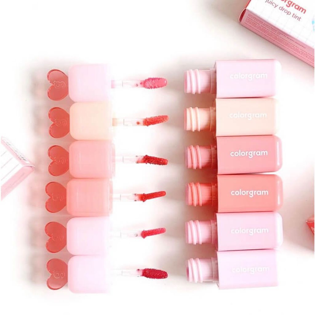 Open Colorgram Juicy Drop Tint 4g lip tints with applicators showing vibrant red and pink shades, perfect for glossy lip makeup.