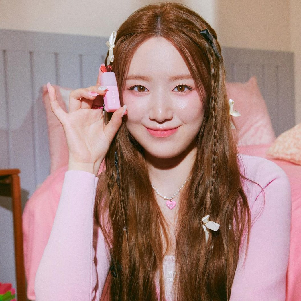 Model holding Colorgram Juicy Drop Tint 4g in pink packaging, highlighting its compact and cute design for lip and cheek use.