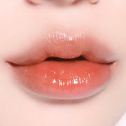 BBIA L'eau Tint 4.5g in a nude peach tone on lips, highlighting its smooth, glossy texture and everyday wearability.