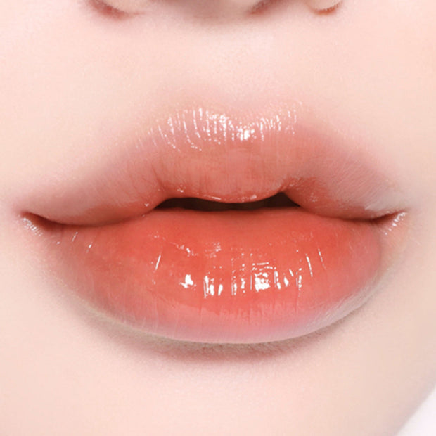 BBIA L'eau Tint 4.5g in a nude peach tone on lips, highlighting its smooth, glossy texture and everyday wearability.