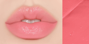 Huxley Lip Balm Leave Behind in bright pink shade shown on lips, delivering a vibrant, glossy finish with skin-loving hydration.