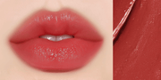 Huxley Lip Balm Leave Behind in deep brick red shade applied on lips, offering intense color payoff with a hydrating, glossy finish.
