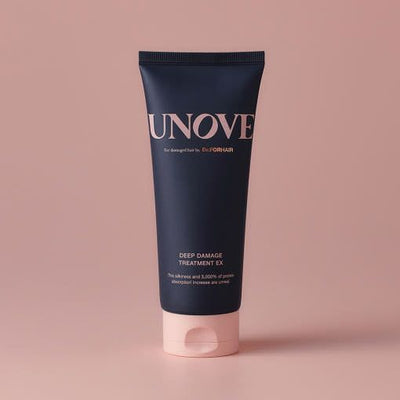 UNOVE Deep Damage Treatment EX 207ml hair treatment in sleek navy tube with pink cap, ideal for restoring damaged, frizz-prone hair.